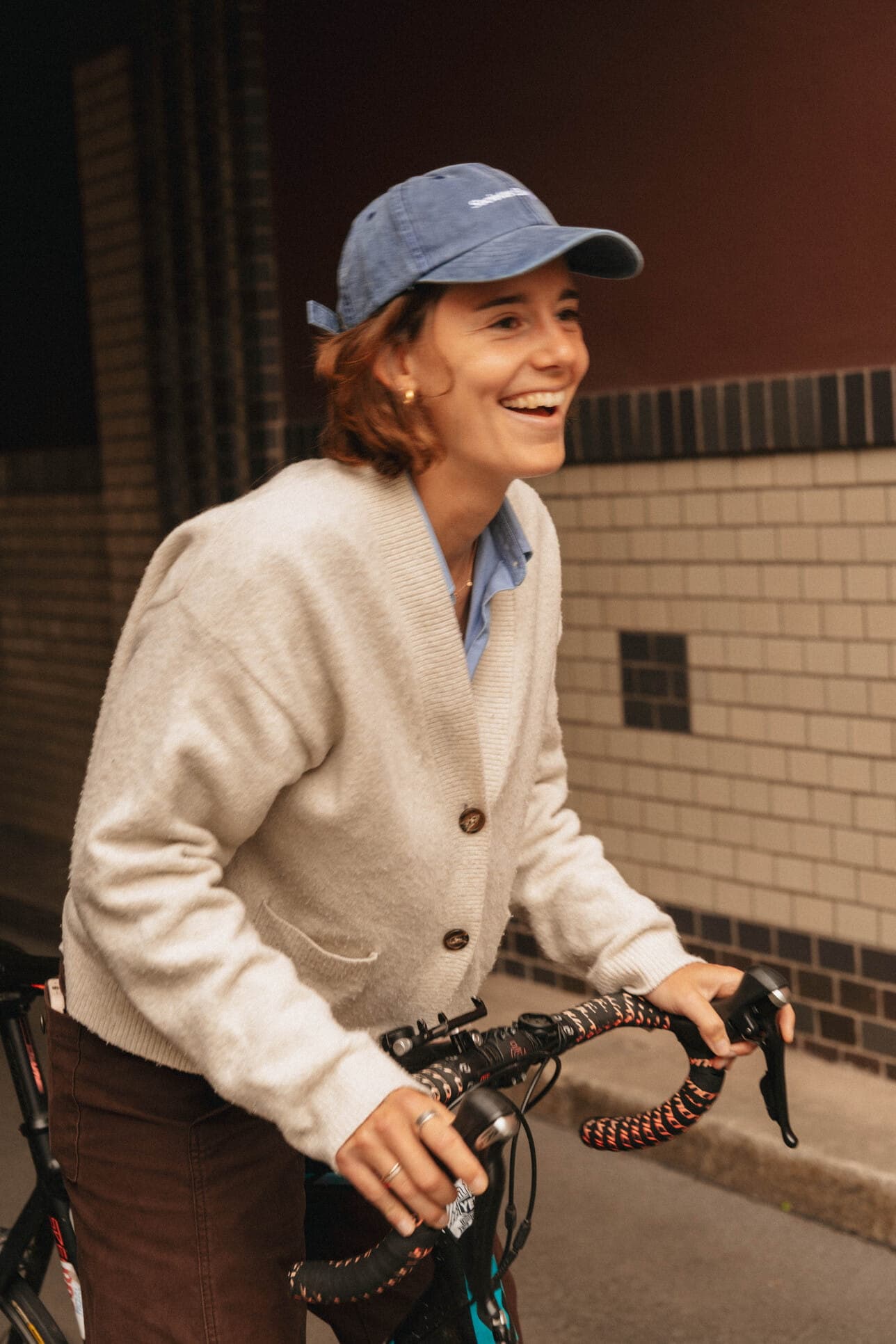 A teammate riding a bicycle along a city street.