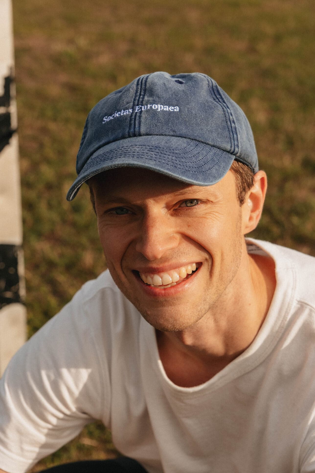 A smiling teammate outdoors in the park.